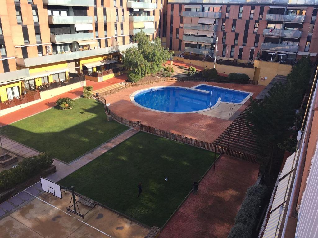 an overhead view of a swimming pool in a city at Spacious Apartment in Terrassa with Shared Pool, 85 m² in Terrassa