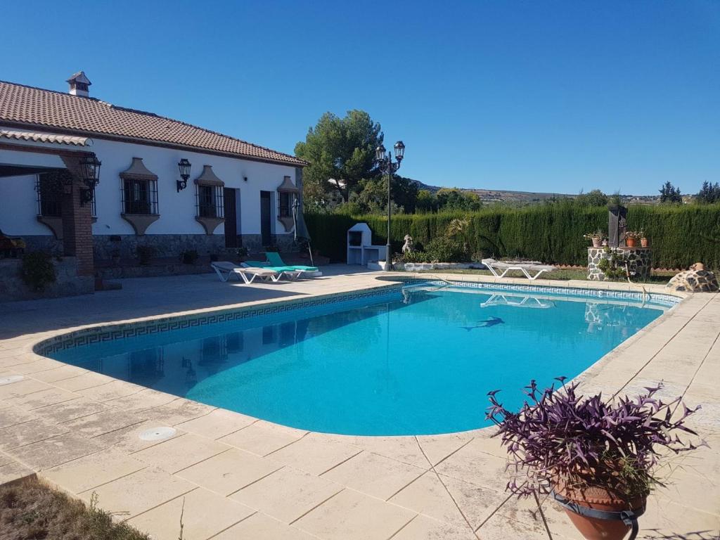 a swimming pool in front of a house at Charming house in Arriate with private pool. in Arriate