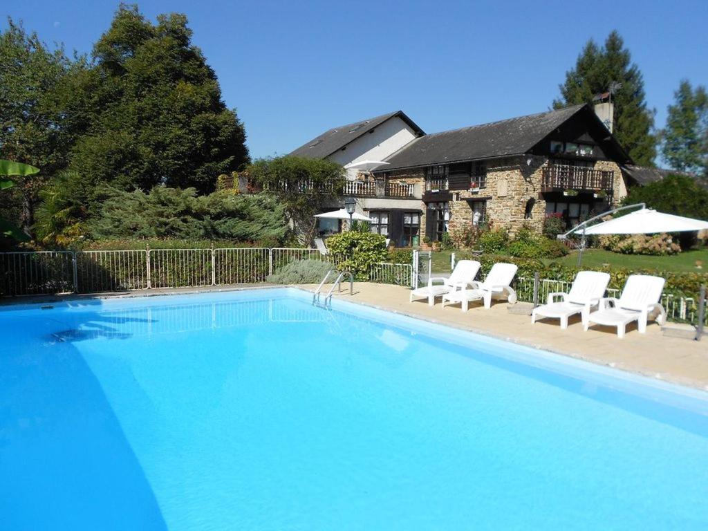 a large swimming pool with chairs and a house at Villa spacieuse à Haut-de-Bosdarros avec piscine privée in Haut-de-Bosdarros
