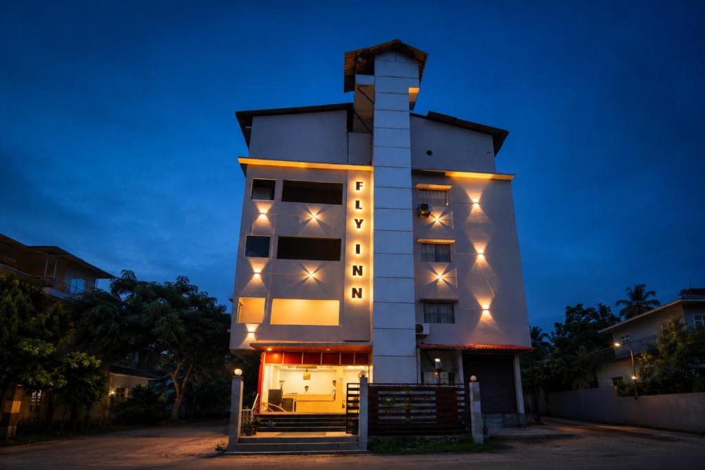 a building with lights on the side of it at Fly Inn in Guwahati