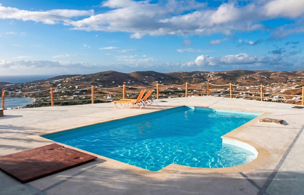 a swimming pool with a view of the ocean at Charming House in Paros, 90 m² with Shared Pool in Parikia