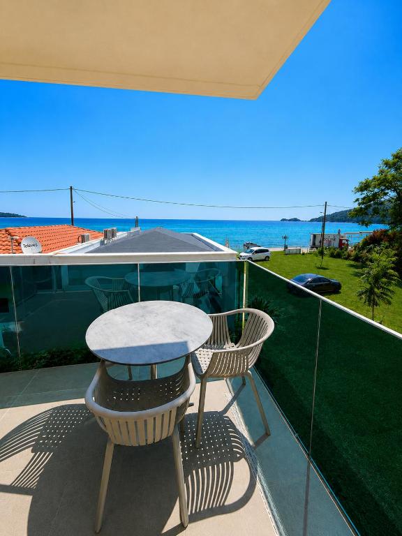 a table and two chairs on a balcony with the ocean at Barocco Villa & Studios in Potamiá