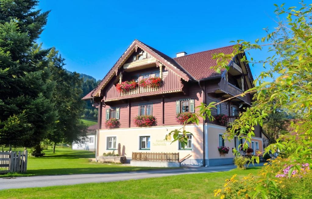 a house in the mountains with flowers on the windows at Charming House in Pruggern, Mountain View in Pruggern
