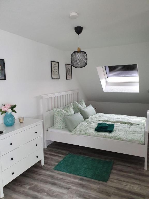 a bedroom with a white bed and a window at Fewo-Am-Tanger in Tangerhütte