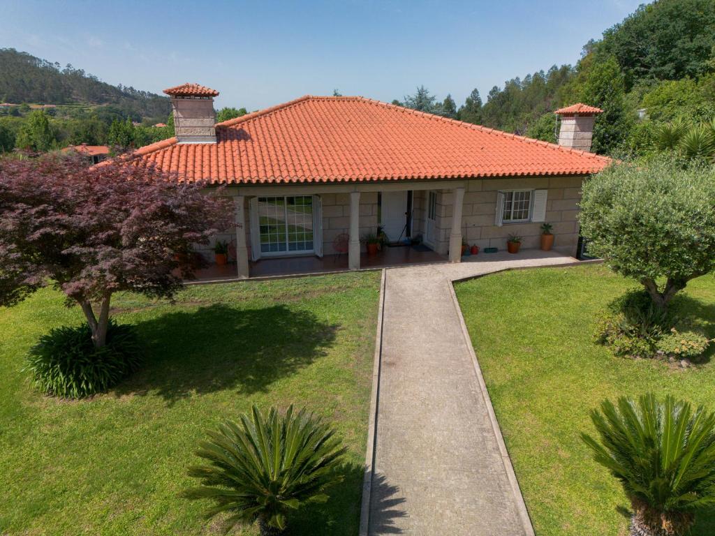 a house with an orange roof and a walkway at Casa Monte Cordova in Monte Córdova