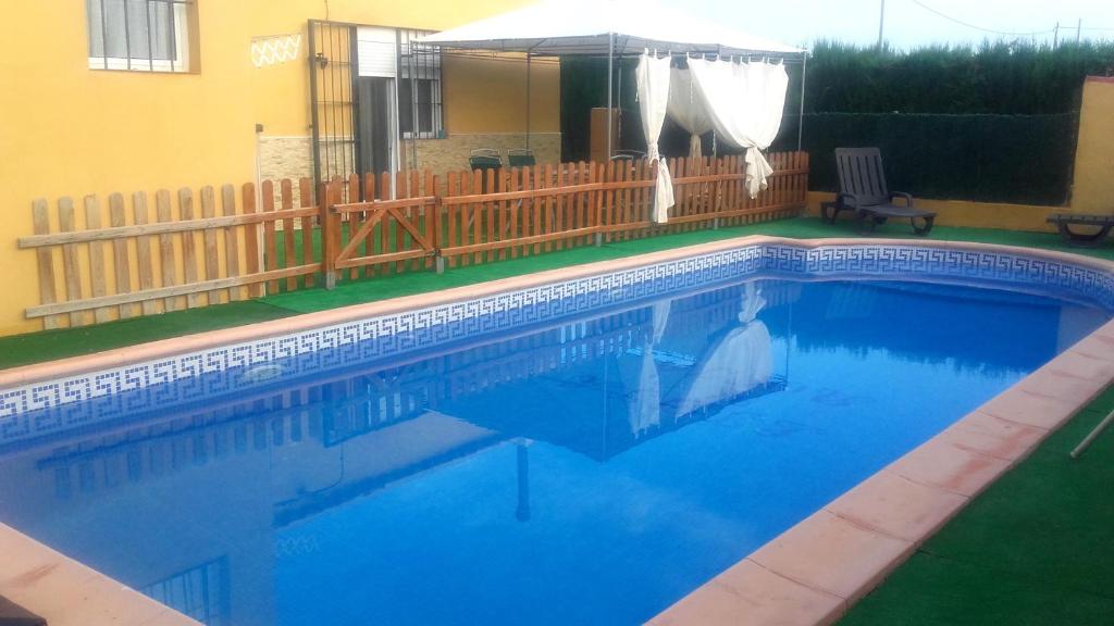 a swimming pool with blue water in a yard at House with private pool in Aguilas, sea & pool view in Águilas