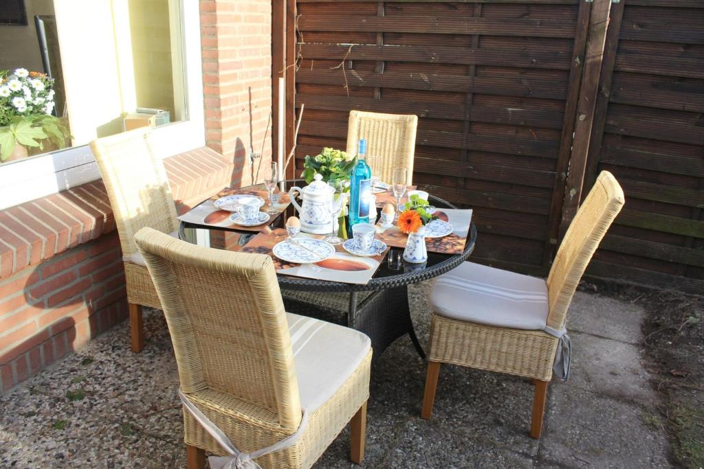 a table and chairs sitting on a patio at Spacious House in Sylt-Ost, Garden in Tinnum