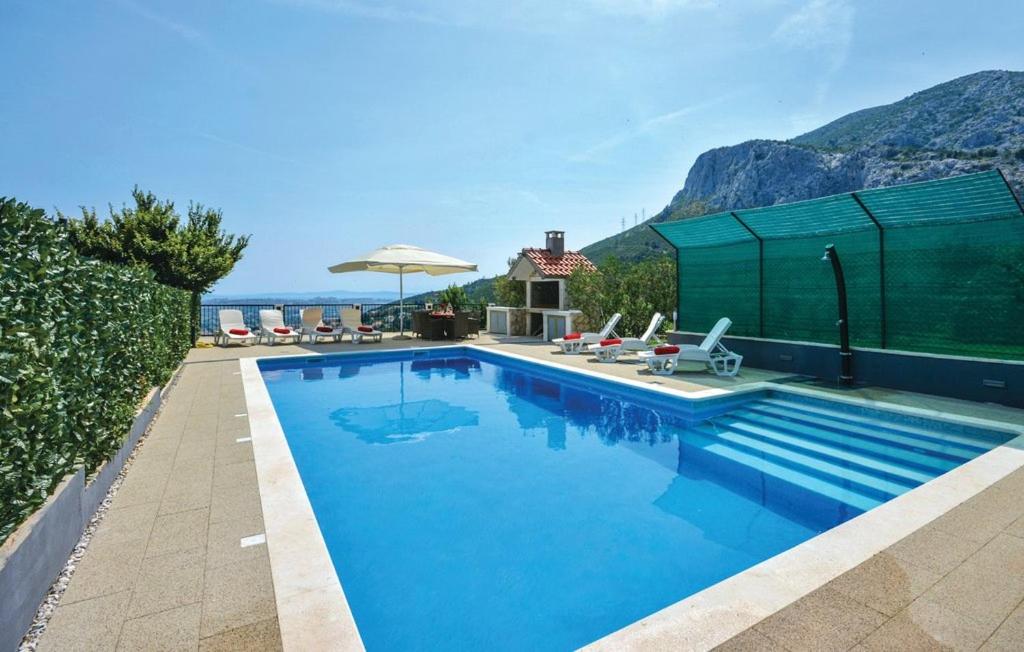 a swimming pool with a mountain in the background at Family Villa in Solin with Pool in Solin