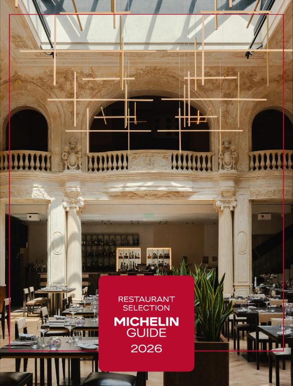 a restaurant with a red sign in front of a building at Grand Hotel in Łódź