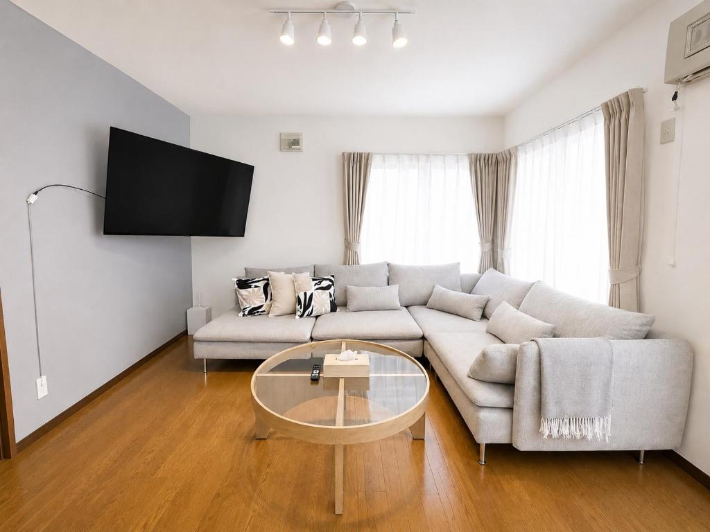 a living room with a couch and a table at 美瑛Stay in Biei