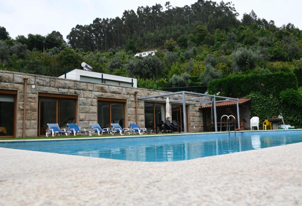 a house with a swimming pool in front of a building at "Spacious villa in Caniçada with year-round private pool" in Caniçada