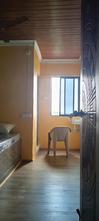a room with a white table and a window at AB lodge in Coimbatore