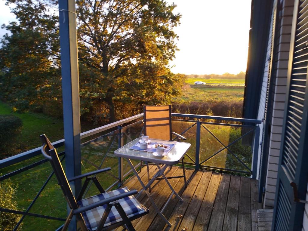a table and two chairs sitting on a balcony at Waack, Brigitte App Nr 7 in Schönberger Strand