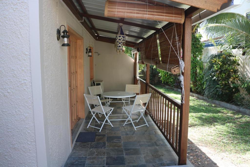 a patio with a table and chairs on a porch at Charming Studio in Blue Bay, 22 m², Near Beaches in Blue Bay