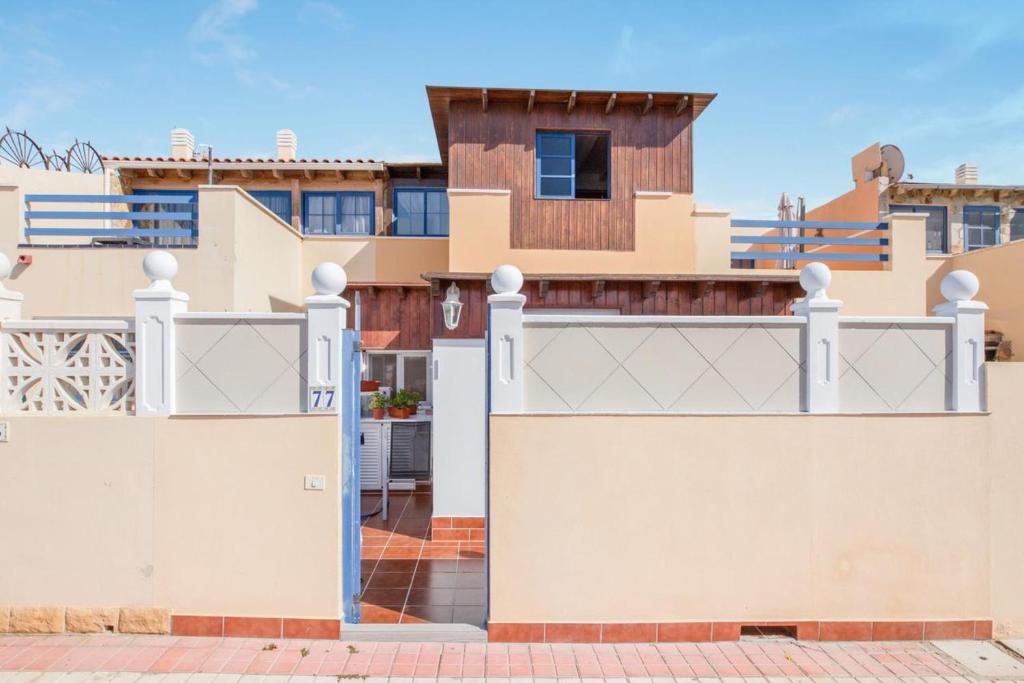 a house with a white fence and a gate at Charming House in Costa Calma with Mountain View and Terrace in Costa Calma