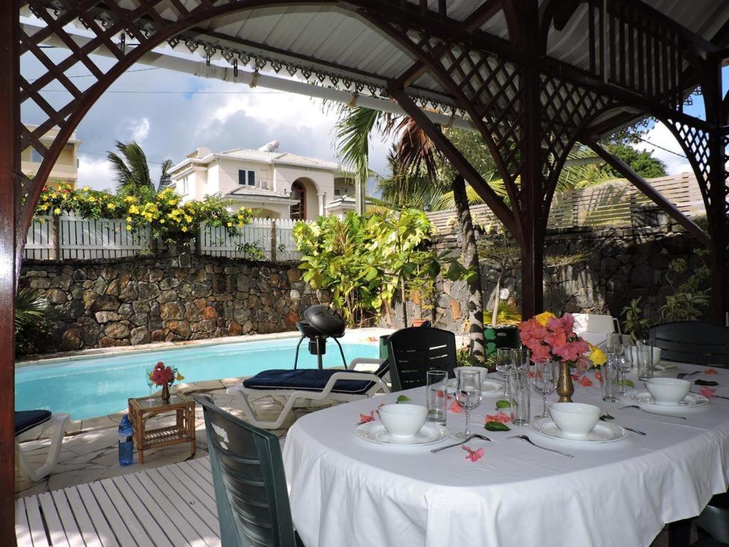 a table set up for a meal in a gazebo at Charming villa in Blue Bay with private pool in Blue Bay