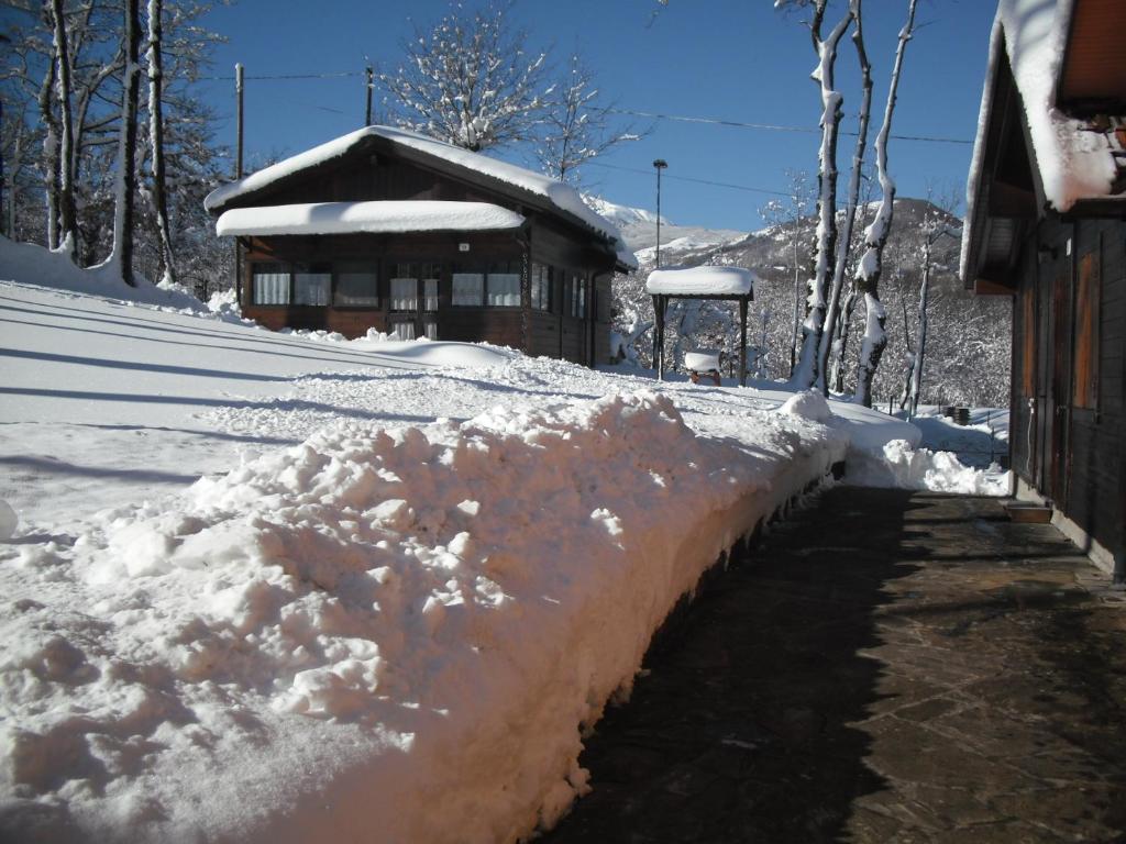 a pile of snow on the side of a house at Comfortable Chalet in Giarola with Mountain View in Busana