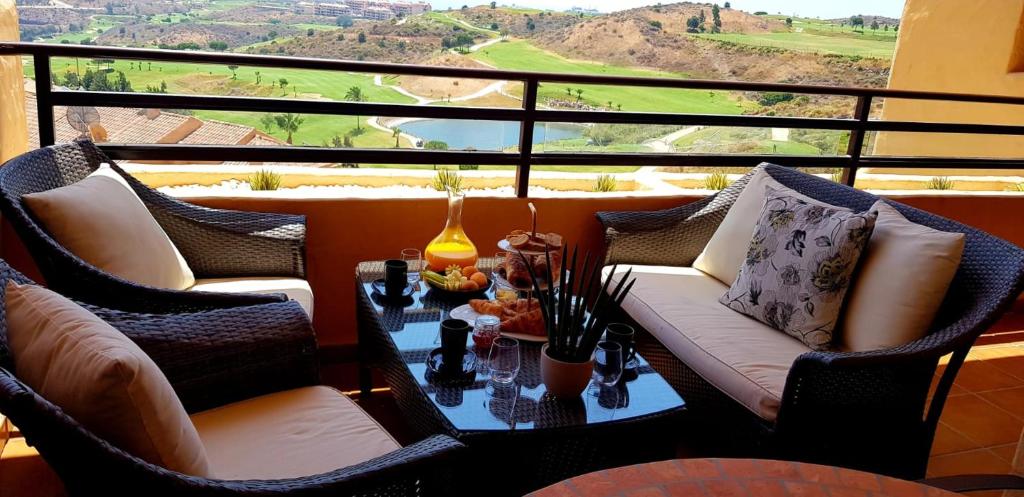 a balcony with a table and chairs with a view at Spacious apartment in La Cala de Mijas with sea view. in La Cala de Mijas
