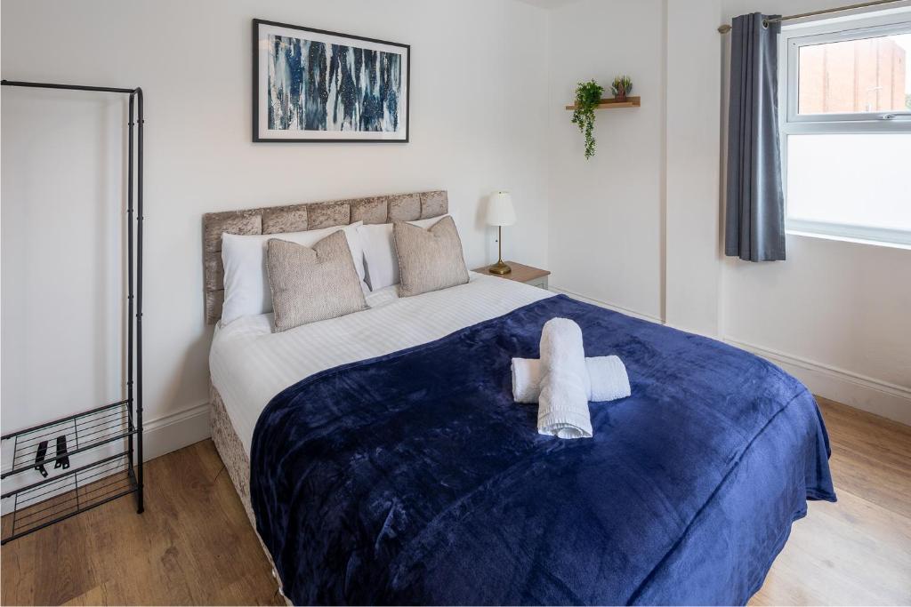 a bedroom with a large bed with two stuffed animals on it at Spacious 2BR APT - Sleeps 5 - Private Parking in Highbridge