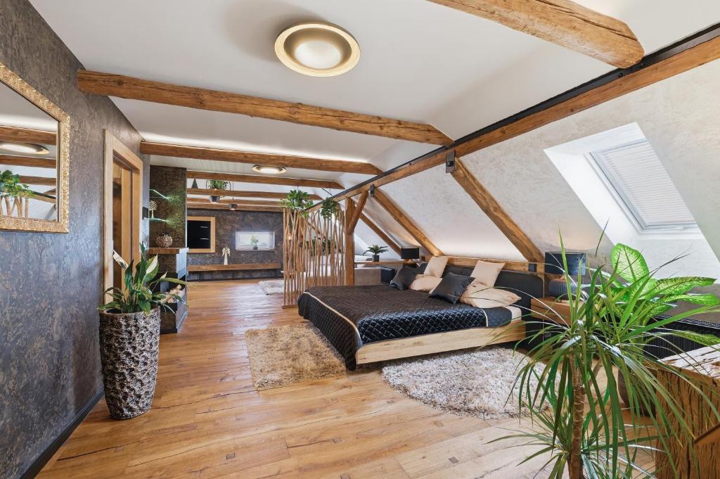 a bedroom with a bed in a room with wooden ceilings at Apartmány Wake up Coffee in Proseč