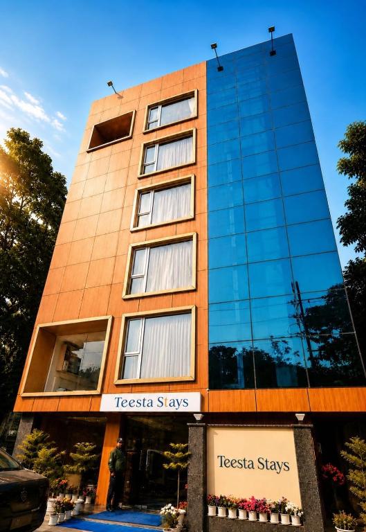a tall building with a sign in front of it at Hotel Teesta Stay, Kolkata in kolkata
