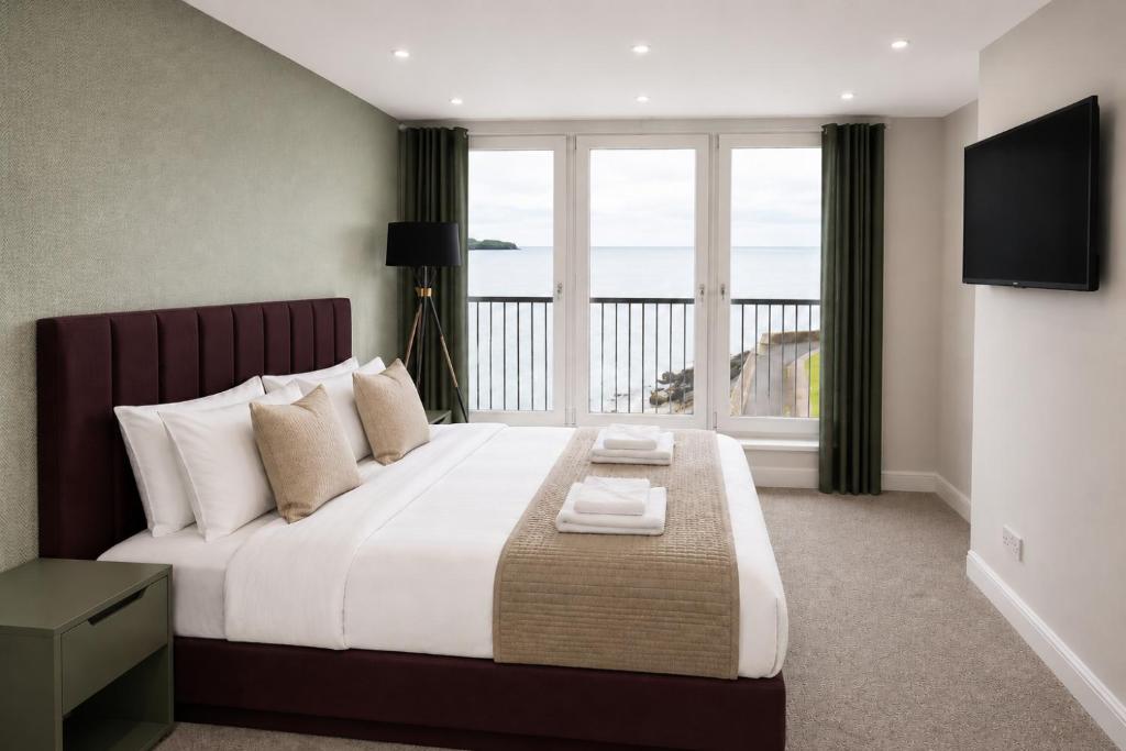 a bedroom with a large bed with a large window at The View from BIDE in Thurso
