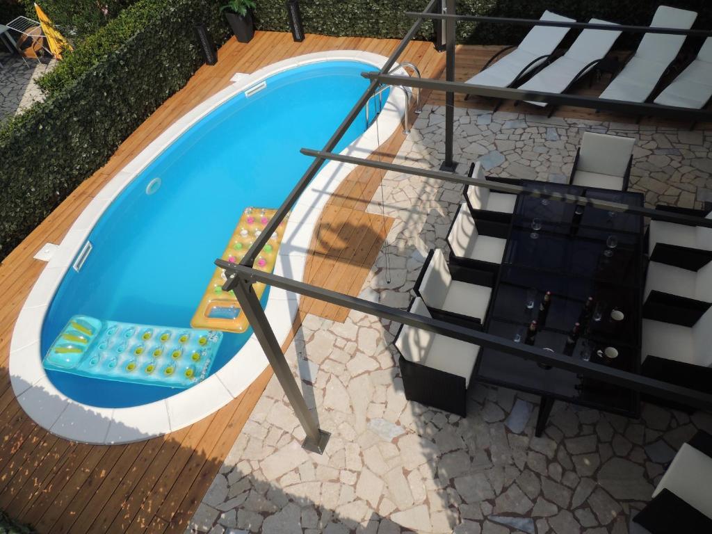 an overhead view of a pool with chairs and a stairway at Welcoming Villa in Vantačići with Pool and Sea View in Vantačići