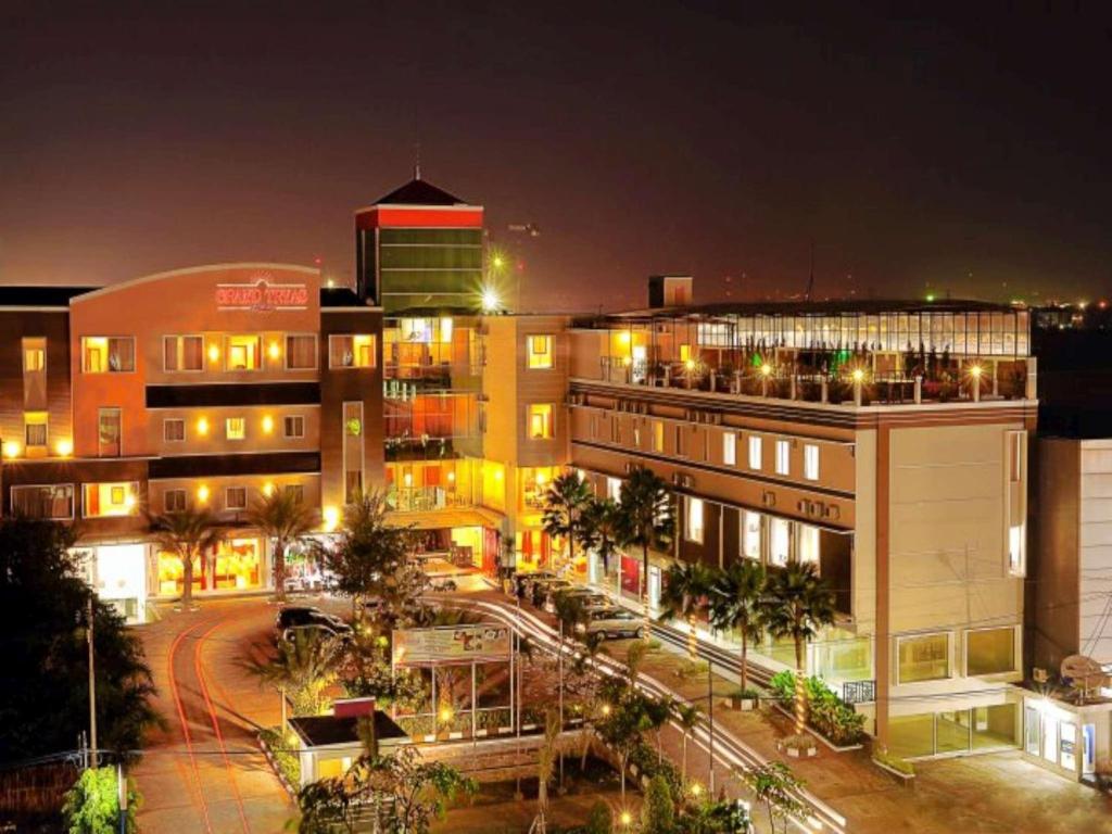 a city at night with buildings and street lights at Grand Tryas Hotel in Cirebon