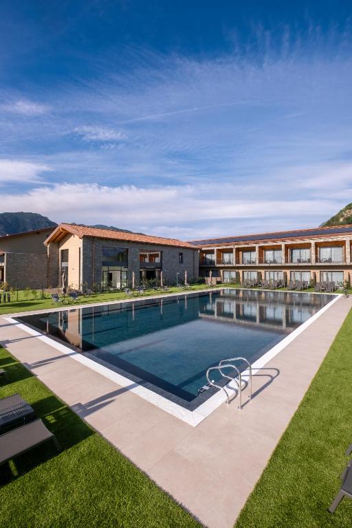 a swimming pool in front of a building at Continental Golf Resort in Verbania