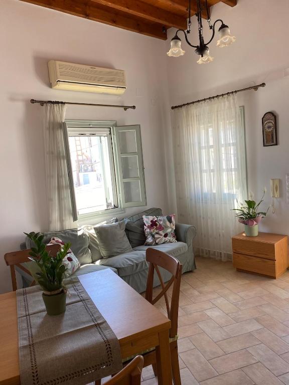 a living room with a couch and a table at EnjoyPatmos in Skala