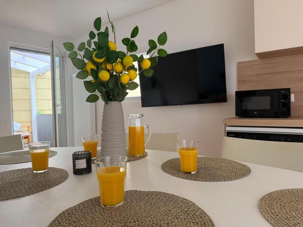 a table with four glasses of orange juice on it at Apartment Itzehoe in Itzehoe