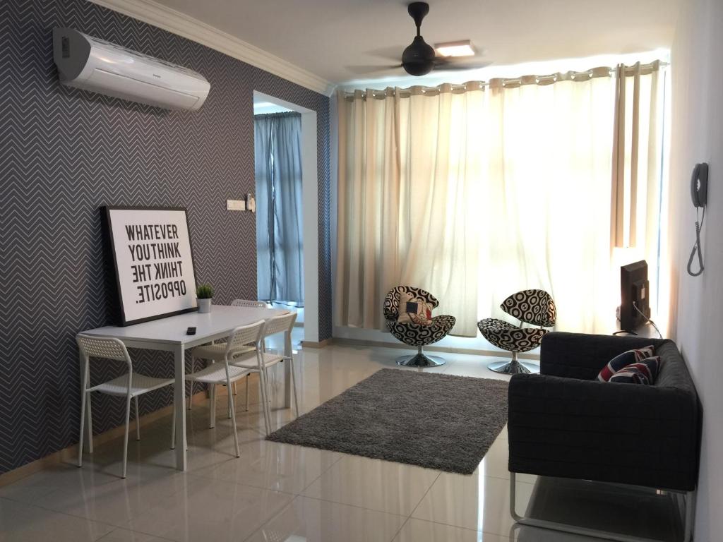 a living room with a dining room table and chairs at VIsta Home Homestay at Vista Alam in Shah Alam