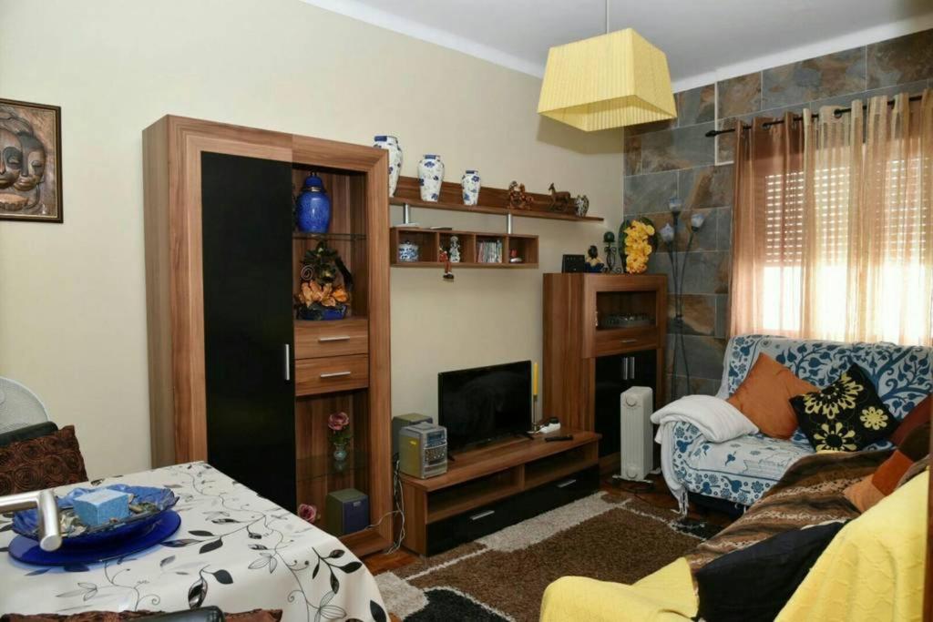 a living room with a couch and a tv at Comfortable apartment with lake view in Vila Real - 75m² in Vila Real de Santo António