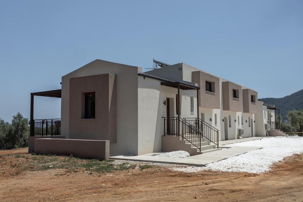 a new house in the middle of a field at Elaionas Houses in Skala Potamias