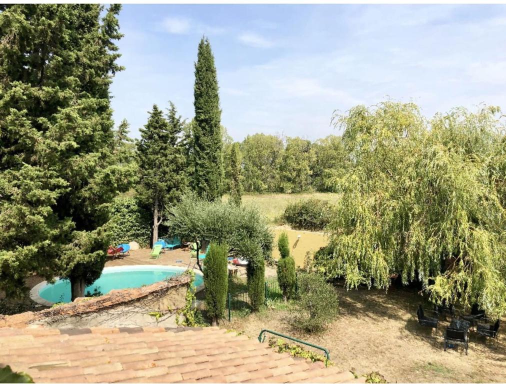 a garden with a swimming pool and trees at Villa avec piscine à Saze in Saze