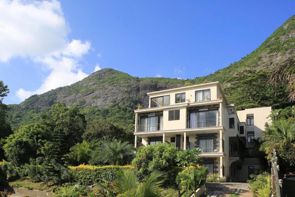 a building in front of a mountain at Charming studio in Moka 40 m² with mountain view terrace in Moka
