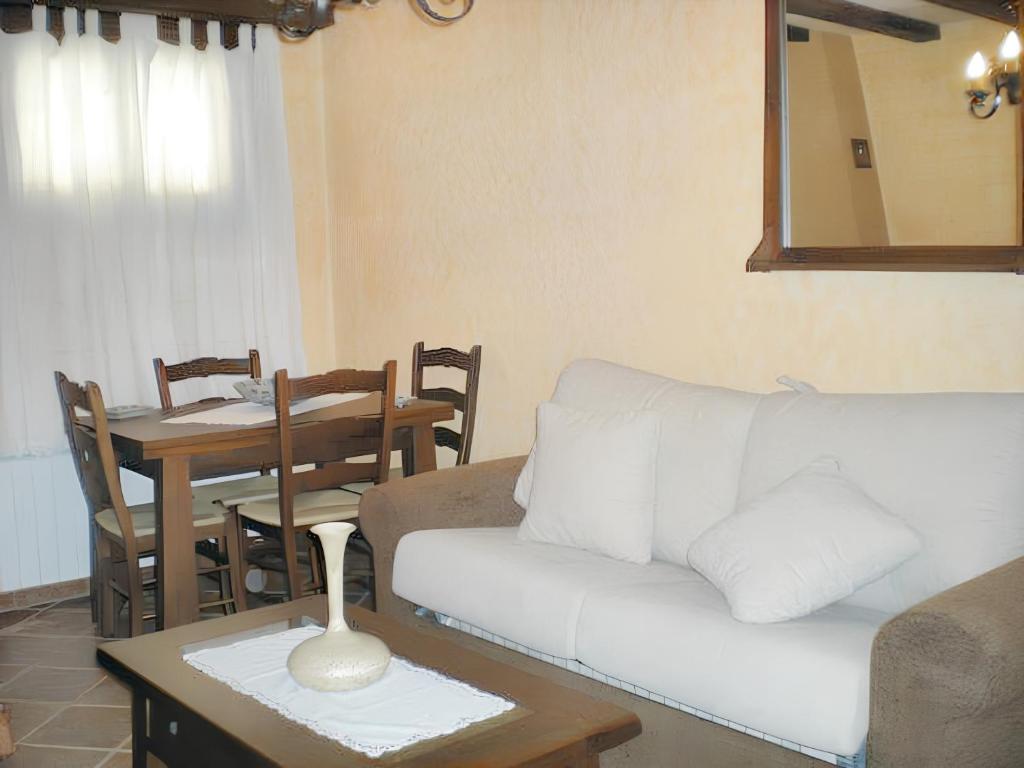 a living room with a couch and a table at Family Apartment with Mountain View in Hueva in Hueva