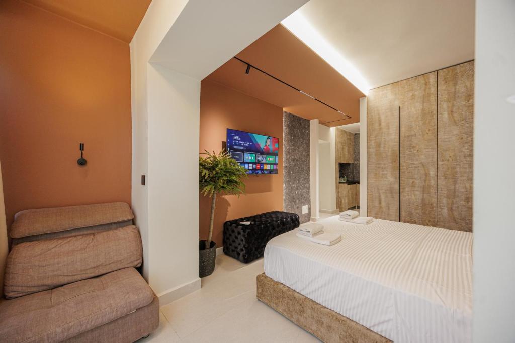 a bedroom with a white bed and a chair at Dreamscape Central in Tirana