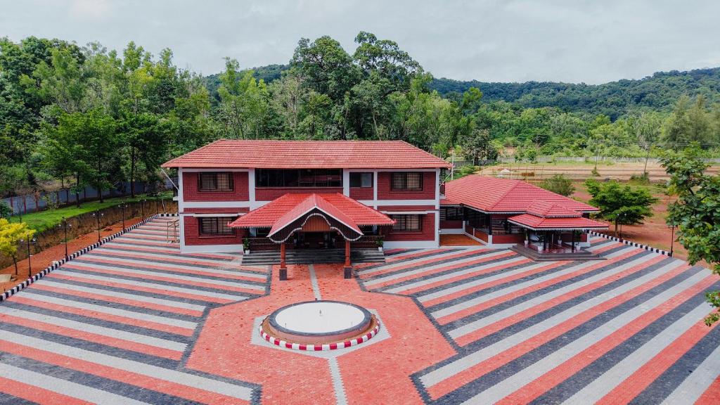 an aerial view of a building with a red roof at Apoorva River Resort in Māvingundi