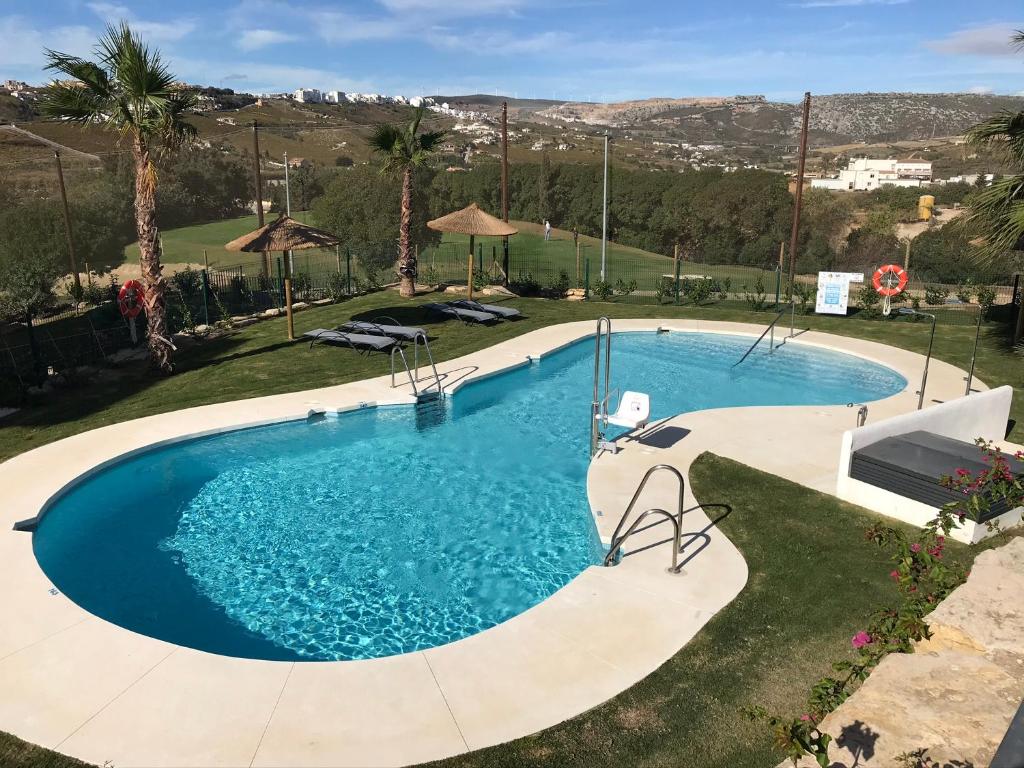 a large swimming pool in the middle of a yard at Spacious Apartment with Views in Málaga, 77 m², Shared Pool in San Luis de Sabinillas