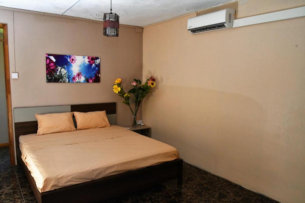 a bedroom with a bed and a vase of flowers at Modern Apartment with Garden and Lake View in Riambel in Riambel