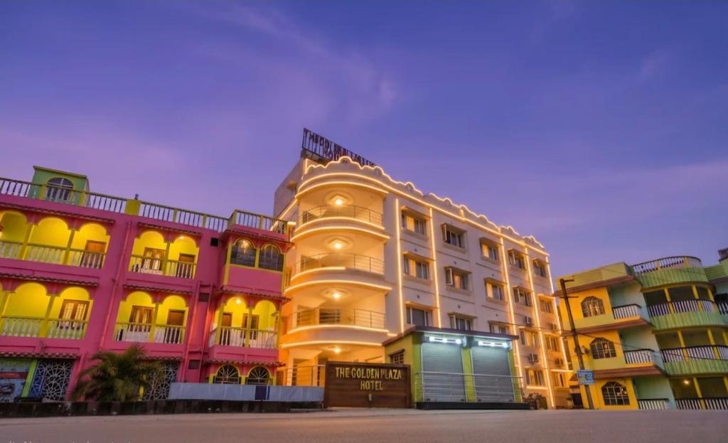 a large white building with a lot of windows at The Golden Plaza in Tarapith