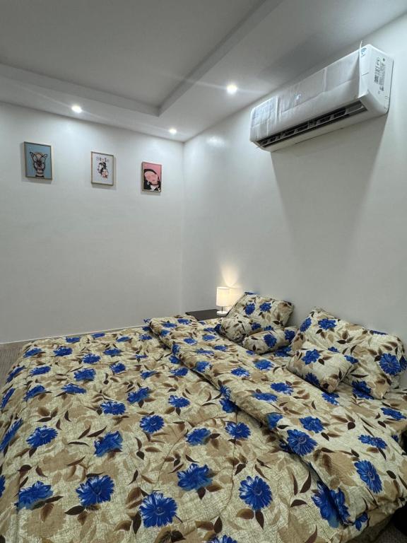a bedroom with a bed with blue flowers on it at استديو الراحه in Ash Shishah