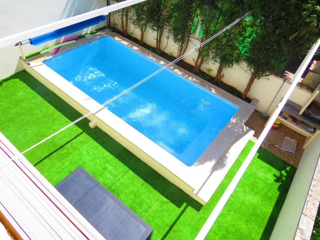 an overhead view of a swimming pool on a lawn at Elegant Villa in Porto with Pool & Jacuzzi in Porto
