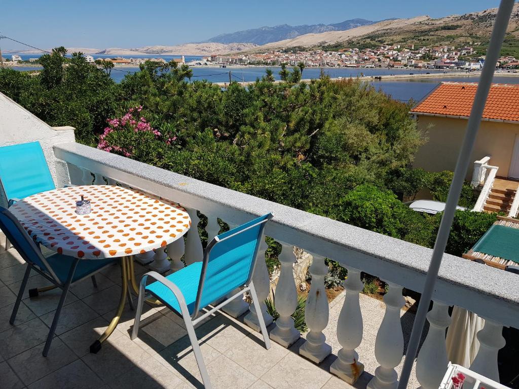 a table and chairs on a balcony with a view at Charming Apartment in Pag with Sea View, 40 sqm in Pag