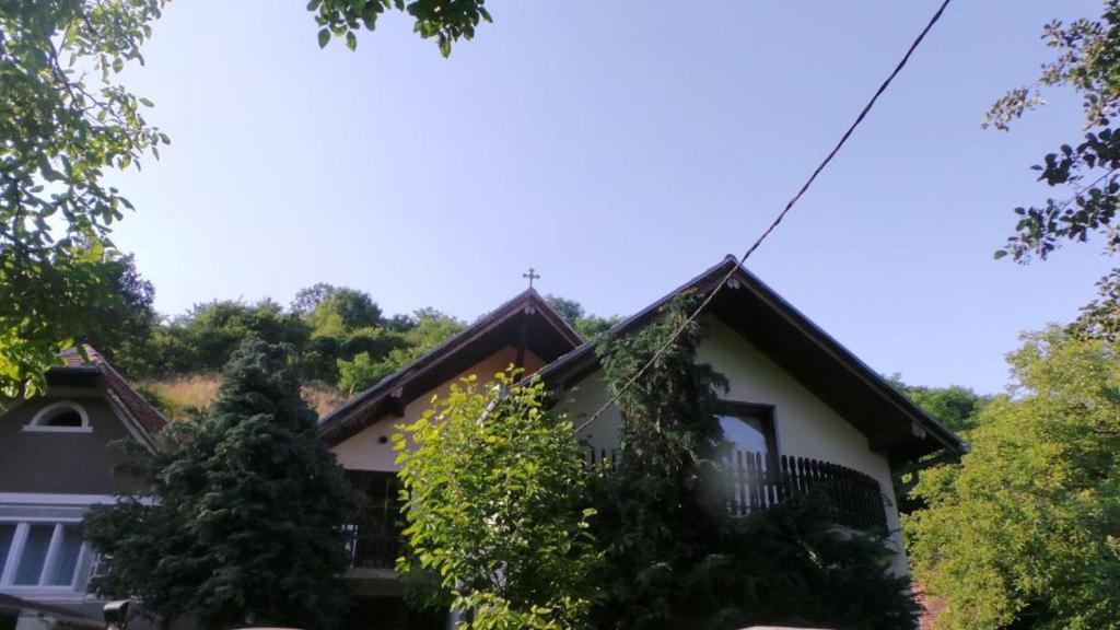 a house with a cross on the roof at Spacious chalet in Sibiel with mountain and lake views + Jacuzzi in Sibiel