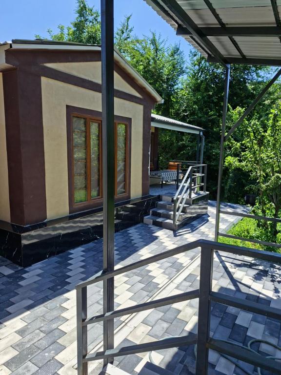a house with a view of a patio at Chimgan Country House in Chimgan