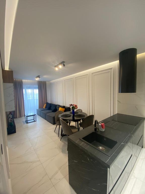 a living room with a couch and a table at Apartamente Arad Premium in Arad