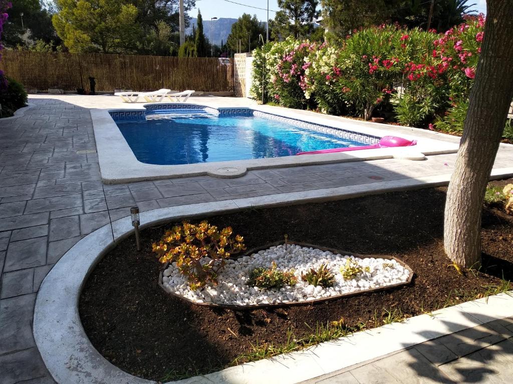 a swimming pool in a yard next to a tree at Seaside Villa in Calafat with Private Pool. in Calafat