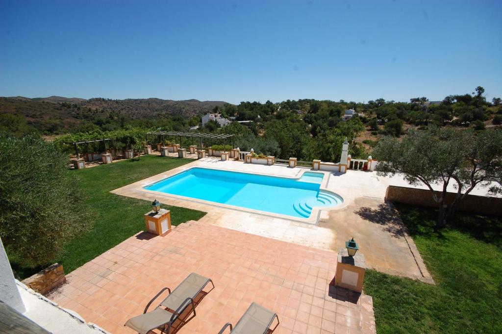 an image of a swimming pool in a yard at Rustic Villa Tavira with Mountain Views and Pool in Tavira